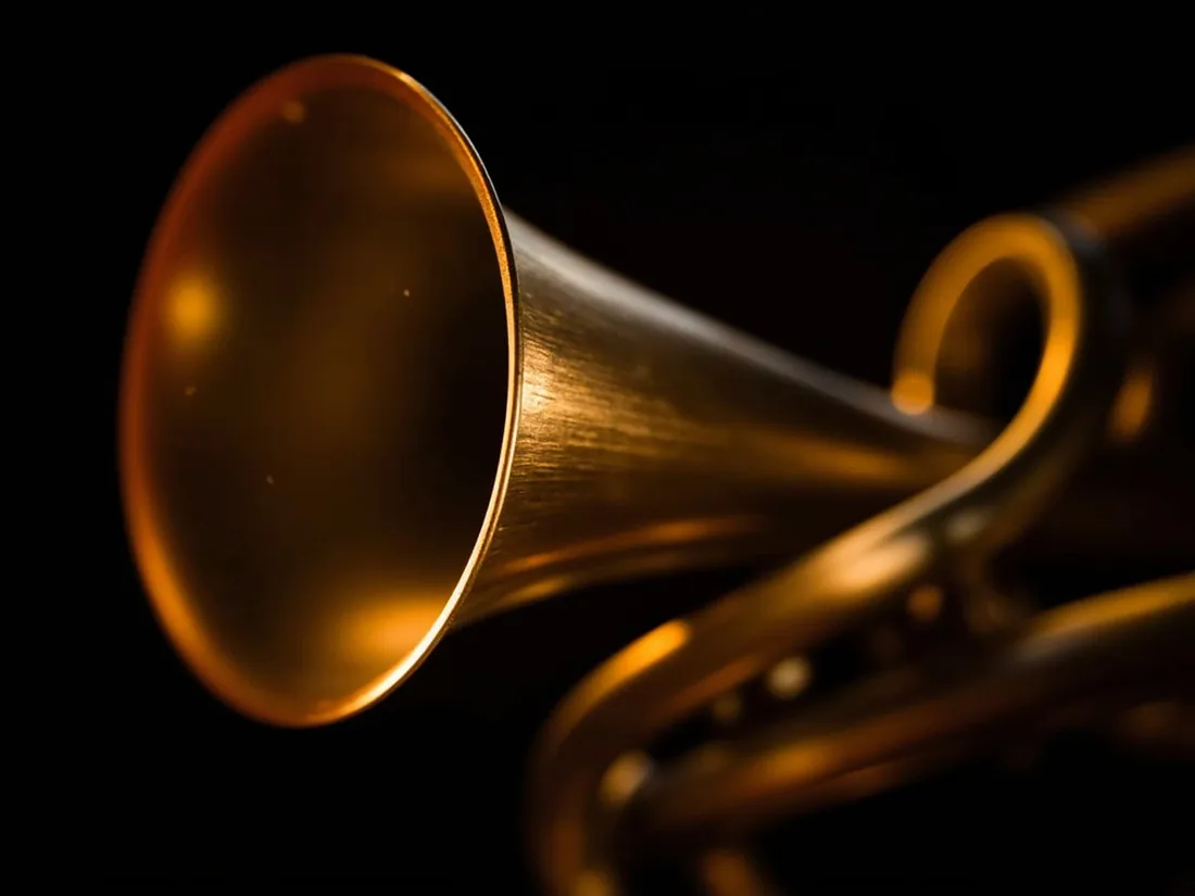 Macro detail of a brass instrument bell, flared rim filling the frame